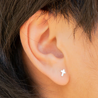 Tiny Sterling Silver Cross Post Earrings on Ear
