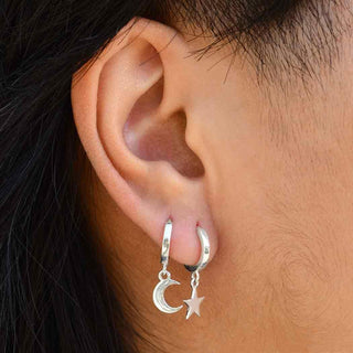 Sterling Silver Star and Moon Huggie Hoop Earrings on Ear