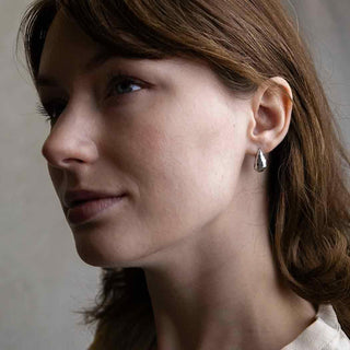 Sterling Silver Hammered Teardrop Huggie Earring on Woman