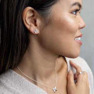 Sterling Silver Ribbon Bow Earrings on Ear