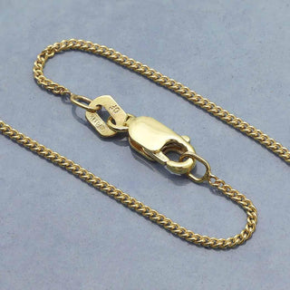 Curb Chain - 14K Gold Filled with clasp on a light blue background