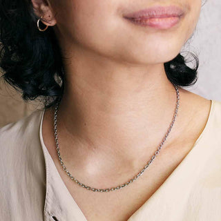 Close-up of a person wearing a Heavy Faceted Oval Chain