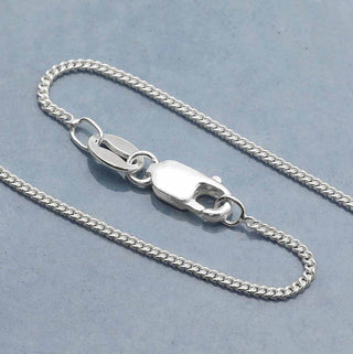 Delicate Curb Chain on light blue background