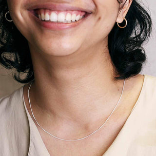 Close-up of a woman wearing a Delicate Curb Chain