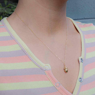 Bronze 3D Anatomical Heart Necklace with gold fill chain on model