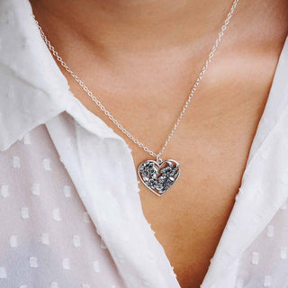 Woman Wearing a Sterling Silver Heart Necklace with Apple Blossoms