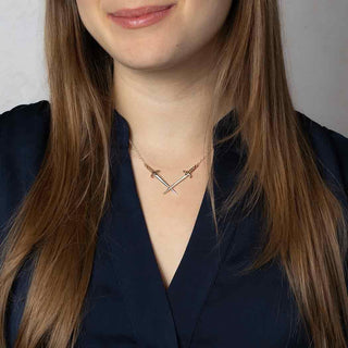 Mixed Metal Crossed Silver Swords Necklace Worn by Female Model