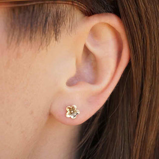 solid 14 karat gold cherry blossom earrings on ear
