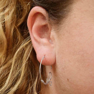 Sterling Silver Hoop Earrings with Teardrop Details on Ear