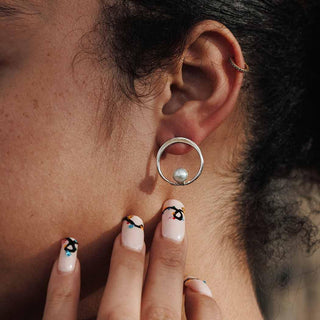 Sterling Silver Circle Earrings with Pearl on Ear