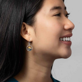 Sterling Silver Mountain Earrings with Bronze Sun on model