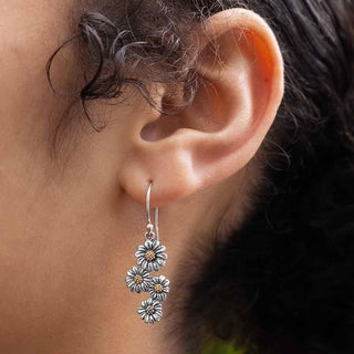 Silver and Bronze Daisy Chain Dangle Earrings on Woman's Ear