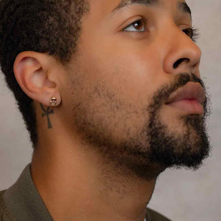 Bronze Mini Skull Earrings on Ear