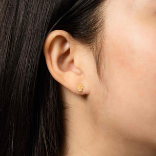 Bronze Mini Skull Earrings on Ear