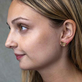 Bronze Monarch Butterfly Earrings on Woman's Ear