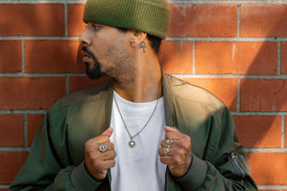Man wearing silver rings and necklace