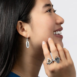 Women wearing silver rings and dangle earring