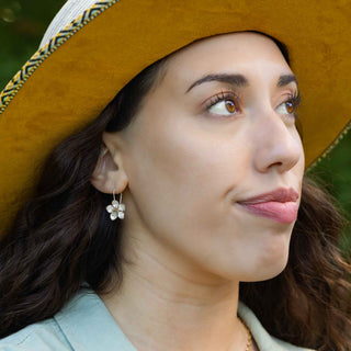 Woman wearing a wide-brimmed hat with a blurred natural background