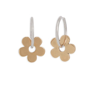 Gold and silver flower-shaped earrings on a white background