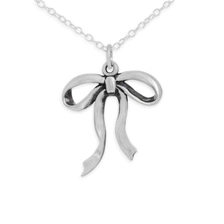 Silver bow-shaped pendant on a chain against a white background