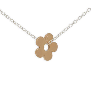 Gold flower-shaped pendant on a silver chain against a white background