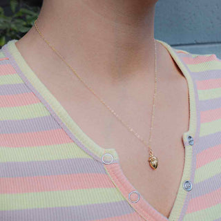 Bronze 3D Anatomical Heart Necklace with gold fill chain on model