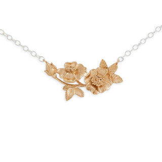 Gold floral necklace on a white background