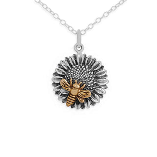 A silver and gold pendant necklace featuring a detailed sunflower design with a small gold bee in the center, suspended from a silver chain on a white background.
