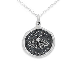 Silver necklace with a pendant featuring a moth design on a white background