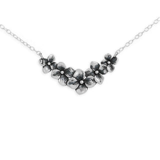 Silver floral necklace on a white background