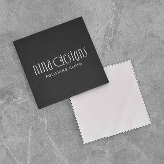 Polishing cloth with black card on a gray stone surface
