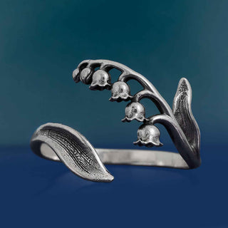 Silver flower-shaped ring on a blue background