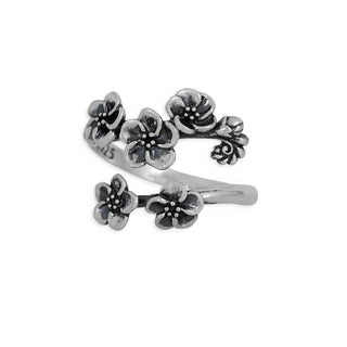 Silver forget me not floral ring on a white background