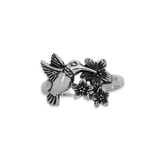 Silver ring with bird and flower designs on a white background