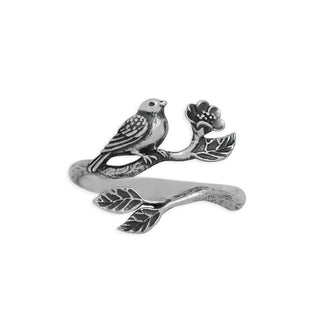A silver-toned open ring band featuring an engraved bird perched on a branch with leaves and a small flower, shown on a plain white background.