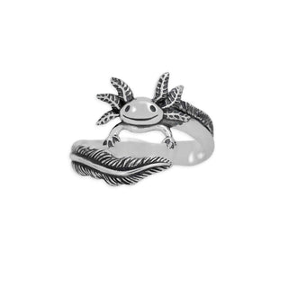 A sterling silver ring featuring a detailed axolotl fish design on a stylized wave band, set against a plain white background.