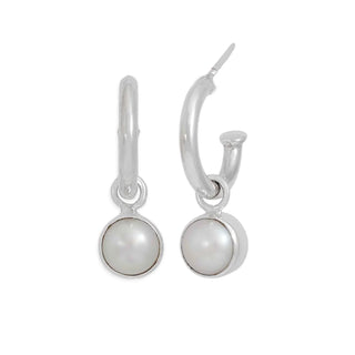 Pair of silver hoop earrings with round pearl drops on a white background