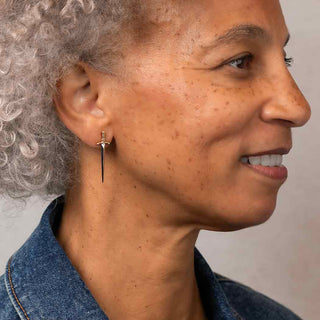Long Silver Sword Earrings Worn on Ear by Woman 