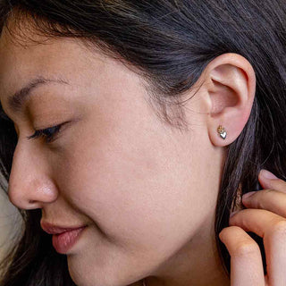 Tiny Flaming Heart Post Earrings on Ear