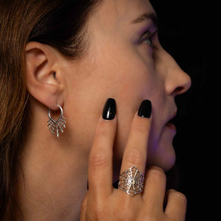 Sterling Silver Spiderweb Huggie Hoop Earrings on model wearing spider web ring.
