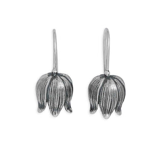 Pair of silver floral earrings on a white background