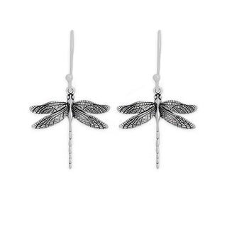 A pair of silver dragonfly drop earrings with detailed textured wings and fishhook backings, shown on a plain white background.