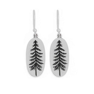 A pair of silver drop earrings with oval pendants featuring a black engraved pine tree design, shown against a plain white background.