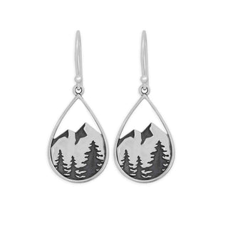 Silver earrings with mountain and tree design on a white background