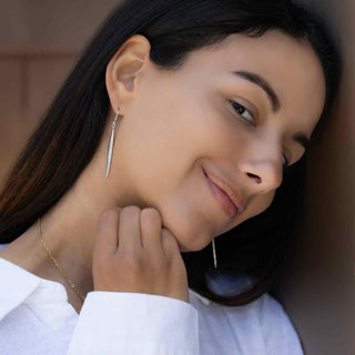Sterling Silver Long Pod Dangle Earrings on model wearing white shirt