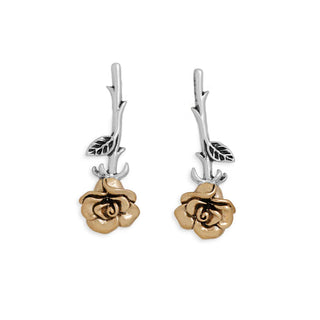 Pair of earrings with bronze rose designs on a white background