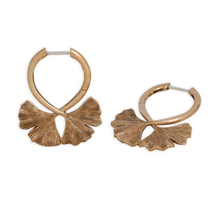Bronze hoop earrings with leaf-like designs on a white background