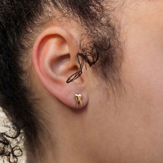 Bronze Tooth earrings on ear