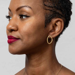 Bronze Asymmetrical Oval Post Earrings on model wearing red lipstick