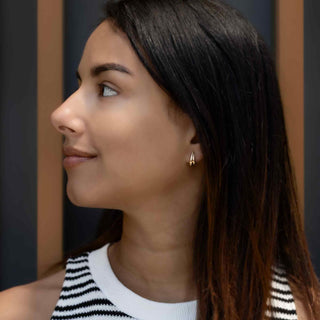 Woman wearing Bronze Double Teardrop Post Earrings with a blurred background